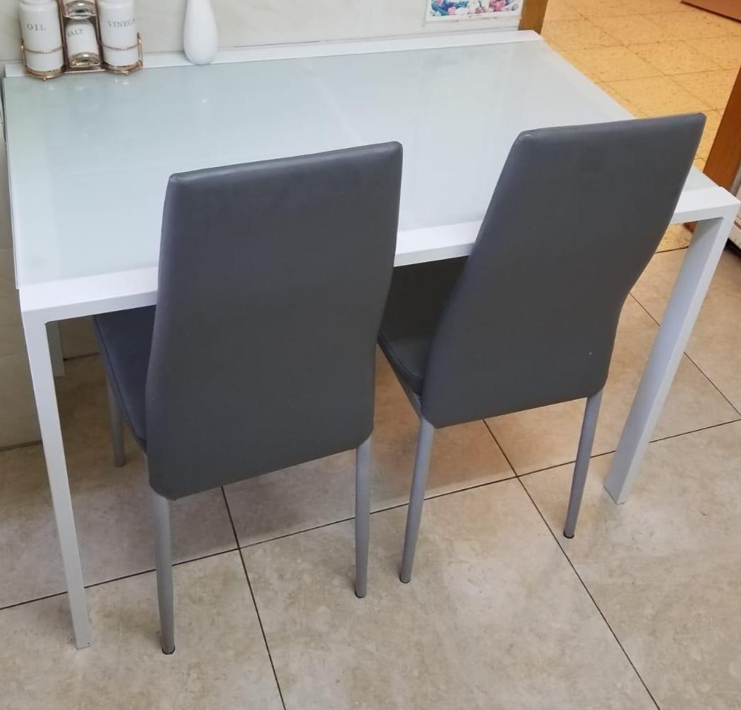 l kitchen table with 2 grey chairs